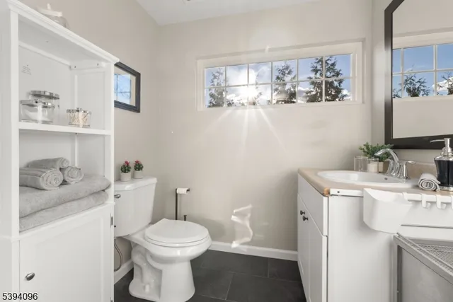 a bathroom with a toilet sink and mirror
