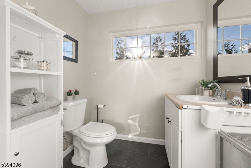 482 Springfield Avenue, Unit 2 Berkeley Heights, NJ 07922 - Photo 14 of 20 a bathroom with a toilet sink and mirror