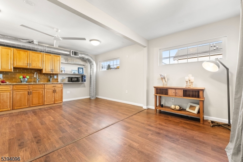 482 Springfield Avenue, Unit 2 Berkeley Heights, NJ 07922 - Photo 4 of 20 a view of a kitchen with a sink cabinets and a living room