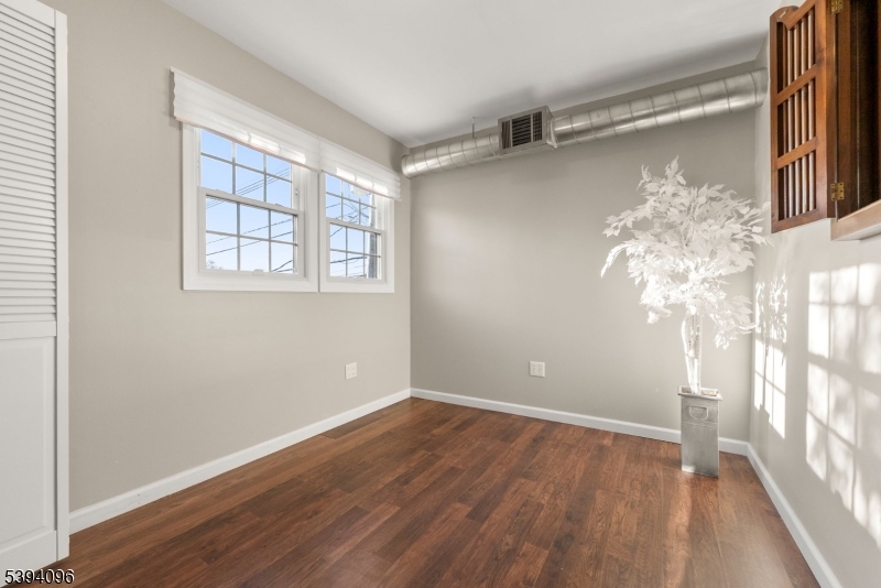482 Springfield Avenue, Unit 2 Berkeley Heights, NJ 07922 - Photo 9 of 20 a view of a room with wooden floor and a window