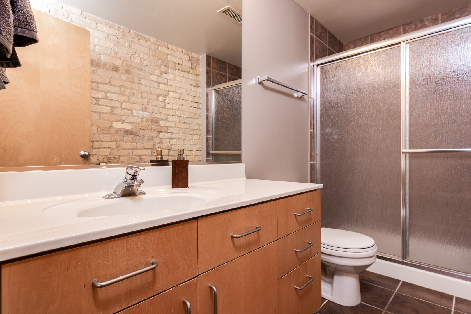 420 South Clinton Street, Unit 306A Chicago, IL 60607 - Photo 13 of 18 a bathroom with a granite countertop sink toilet and shower