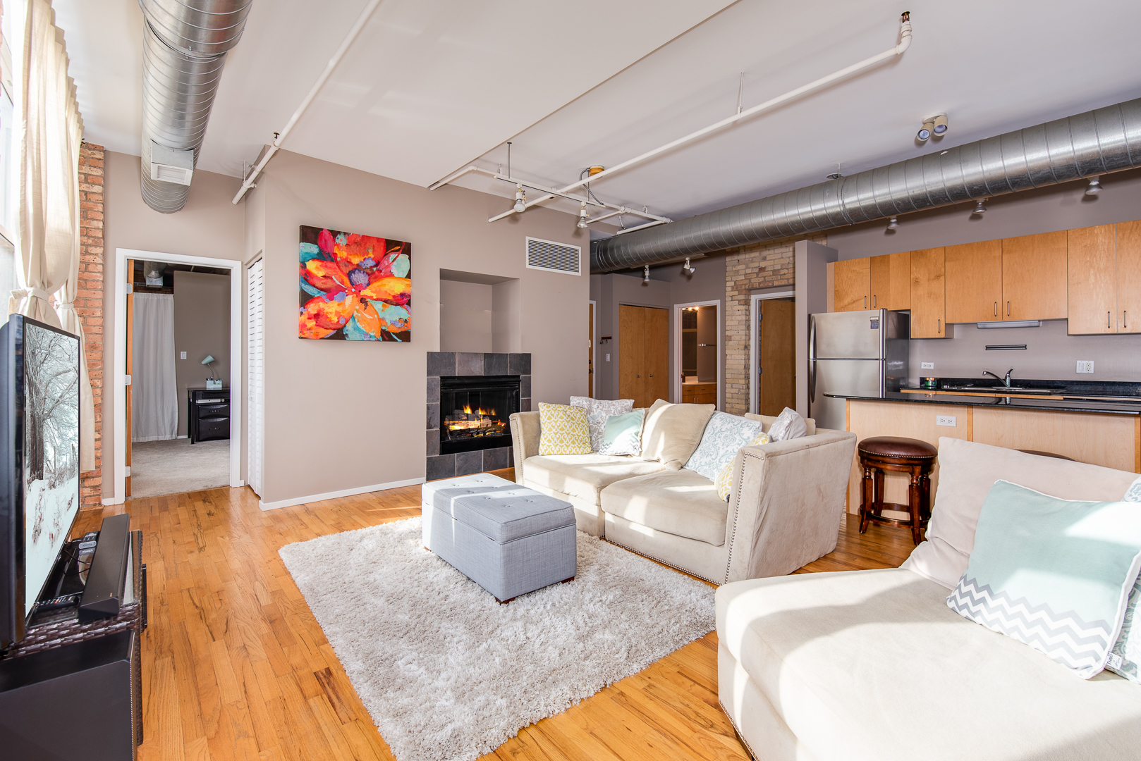 420 South Clinton Street, Unit 306A Chicago, IL 60607 - Photo 3 of 18 a living room with furniture and a flat screen tv