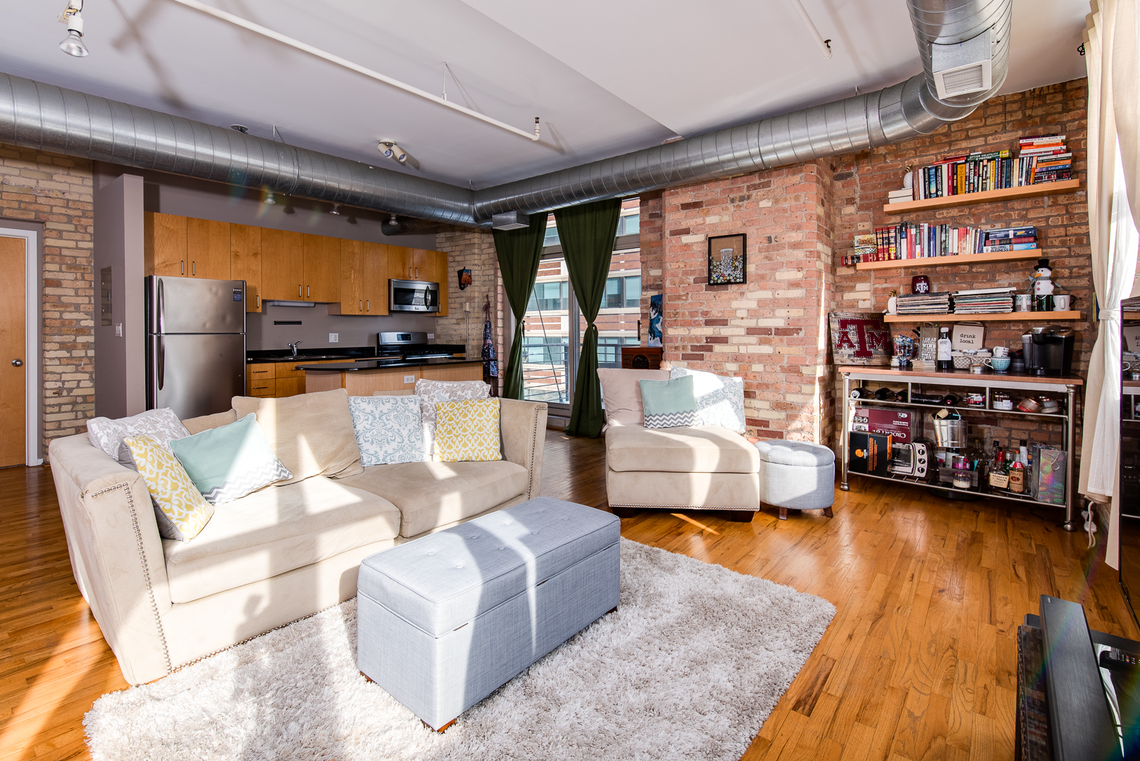 420 South Clinton Street, Unit 306A Chicago, IL 60607 - Photo 8 of 18 a living room with furniture and a book shelf