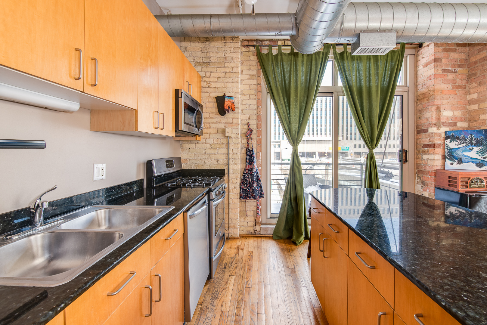 420 South Clinton Street, Unit 306A Chicago, IL 60607 - Photo 10 of 18 a kitchen with a sink a counter top space and living room view