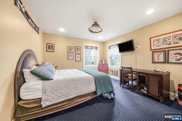 a spacious bedroom with a bed and a table in it