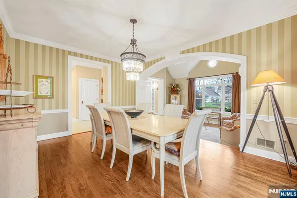 a view of a dining room with furniture wooden floor and a chandelier