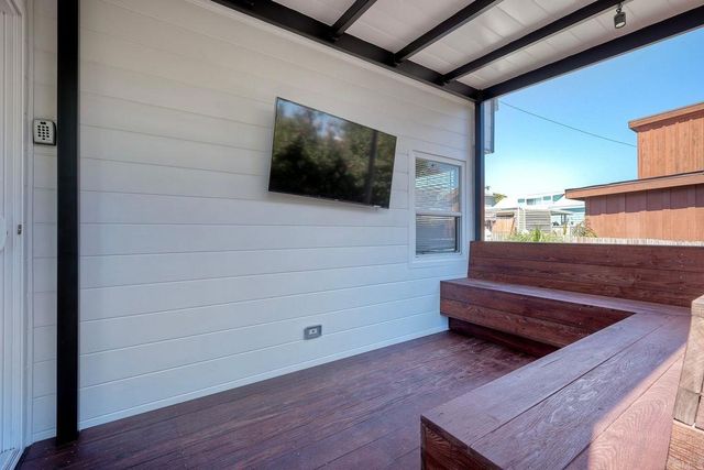 a view of room with wooden floor and windows