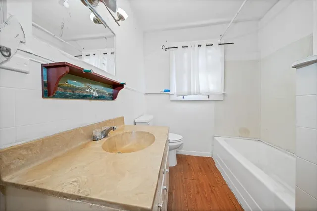 a bathroom with a sink a toilet and bathtub