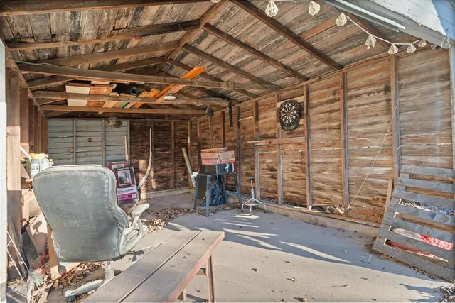 a room with water heater and a wooden floors