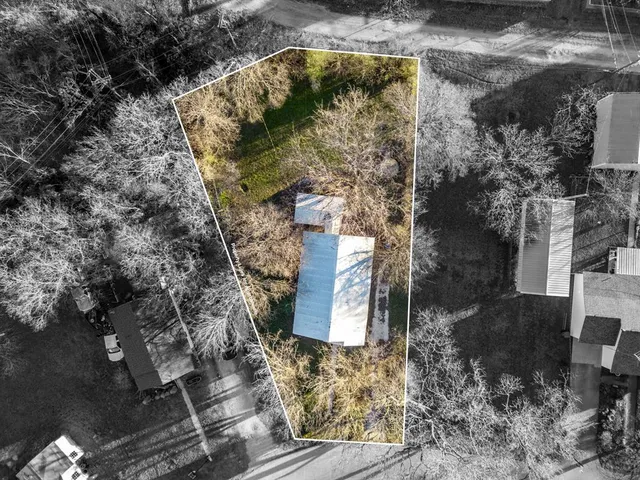 a aerial view of a house with a yard