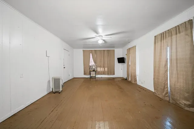 a view of a livingroom with an empty space and a window