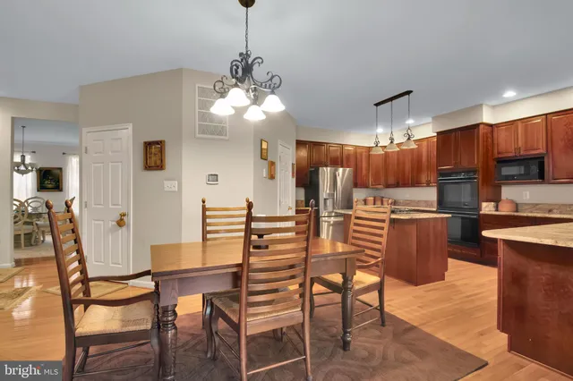 a view of a dining room with furniture and chandelier