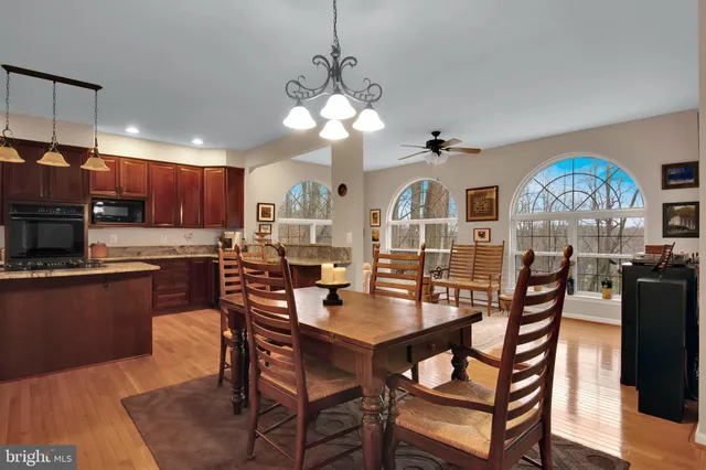 a view of a dining room with furniture a kitchen and chandelier