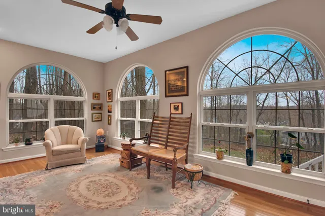 a living room with furniture a rug and a large window