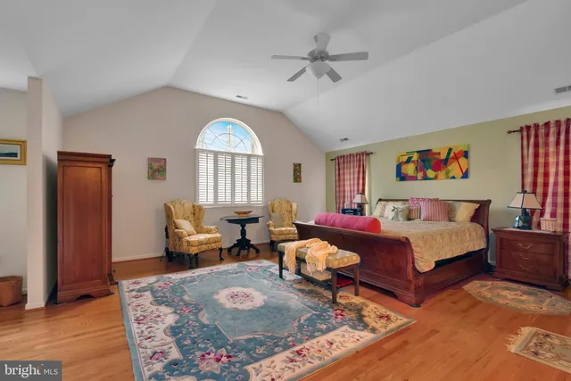 a spacious bedroom with a bed and a couch