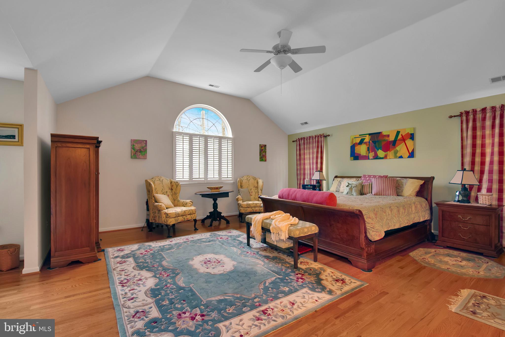 5534 Nutwell Sudley Road Deale, MD 20751 - Photo 28 of 51 a spacious bedroom with a bed and a couch