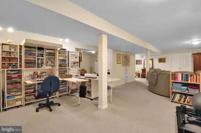 a view of a livingroom with workspace and a couch