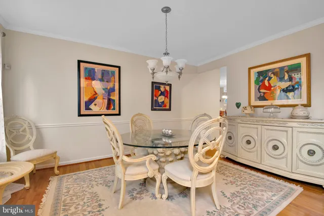 a dining room with furniture a rug and a chandelier