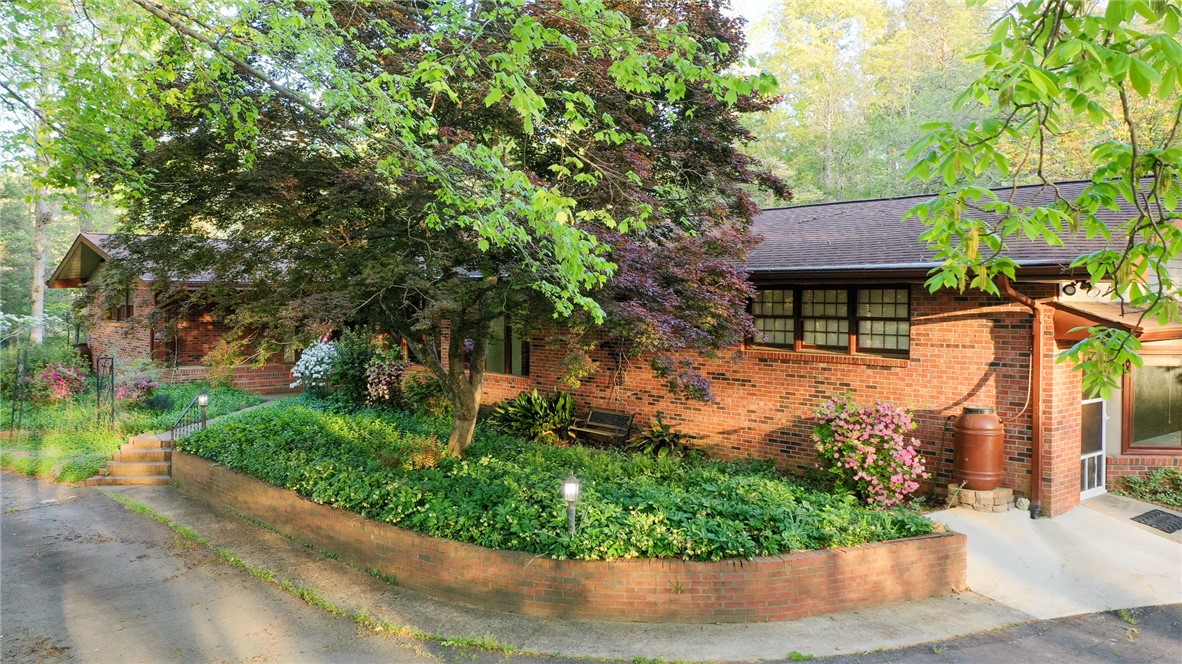 139 Todds Creek Road Central, SC 29630 - Photo 43 of 45 This charming brick home offers a verdant, inviting curb appeal set amidst lush landscaping.