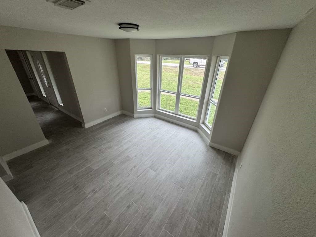529 Brandon Road Conroe, TX 77302 - Photo 5 of 13 wooden floor in an empty room with a window