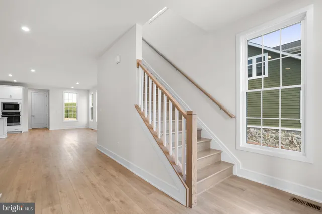 a view of an entryway with wooden floor and windows