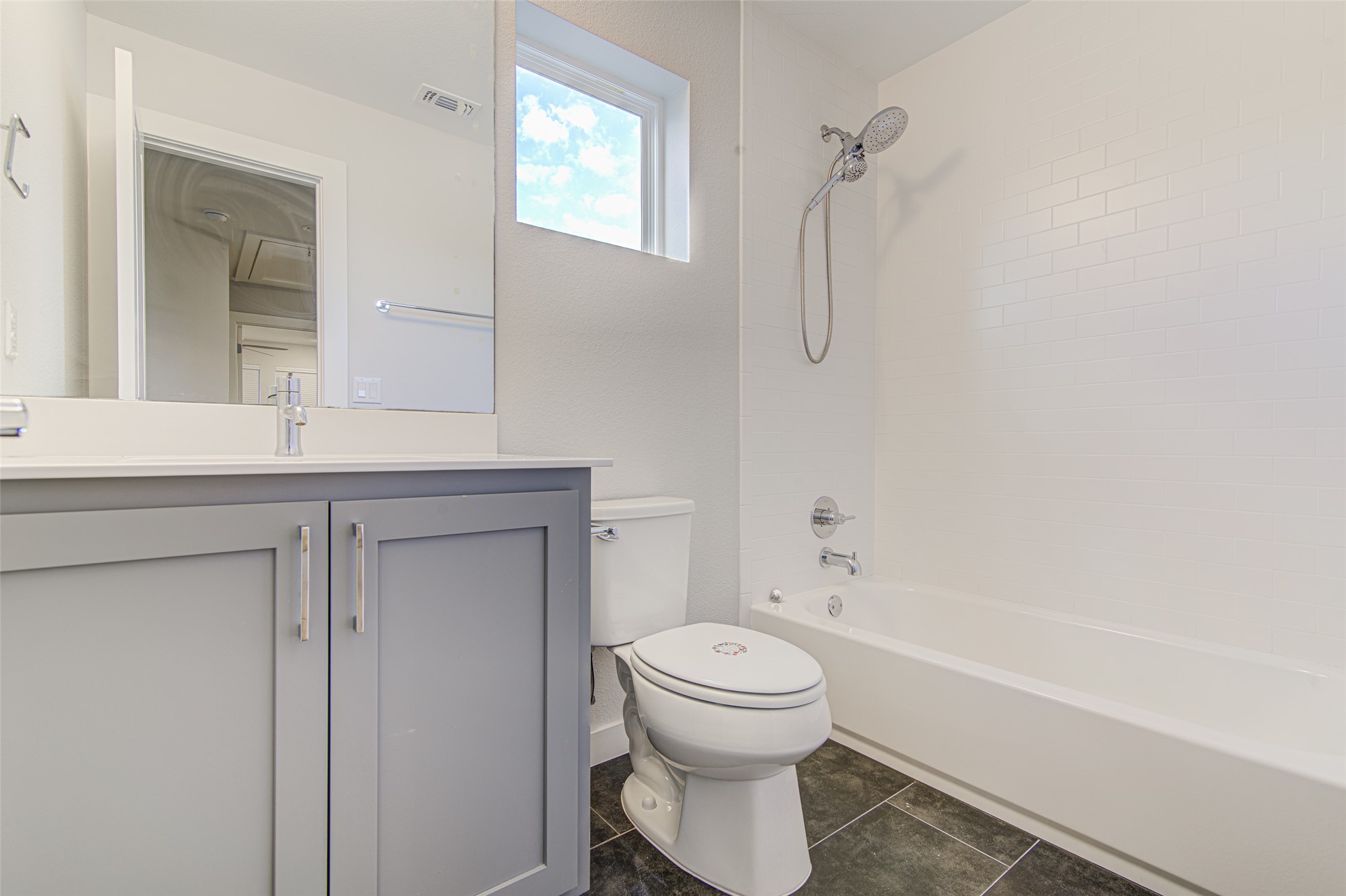 1904 Bunche Road, Unit B Austin, TX 78721 - Photo 18 of 29 Full bathroom upstairs with a quartz vanity, tub/shower combination, and built-in storage.