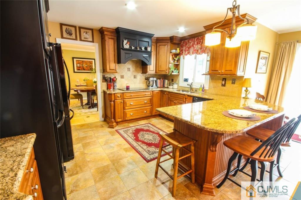 32 Summerall Road Somerset, NJ 08873 - Photo 7 of 17 a dining hall with stainless steel appliances a dining table and chairs with wooden floor