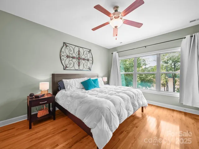 a bedroom with a large bed and a chandelier