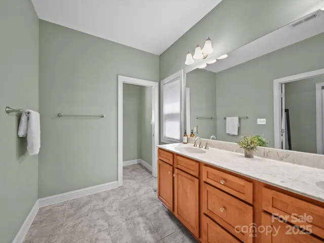 a bathroom with a double vanity sink and a mirror