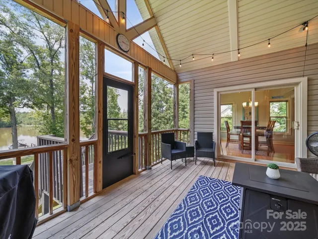 a view of a chairs and table in the roof deck