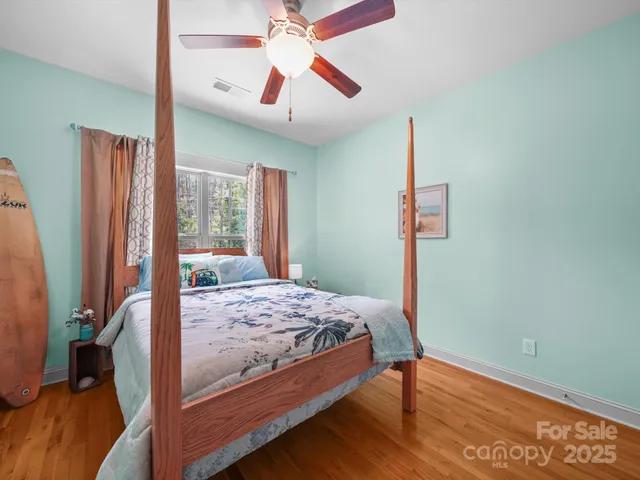 a spacious bathroom with a granite countertop sink a toilet a mirror and a shower