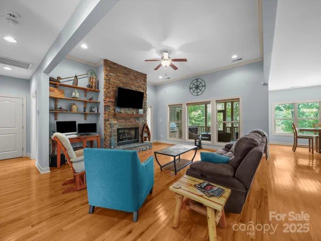 a living room with fireplace furniture and a flat screen tv