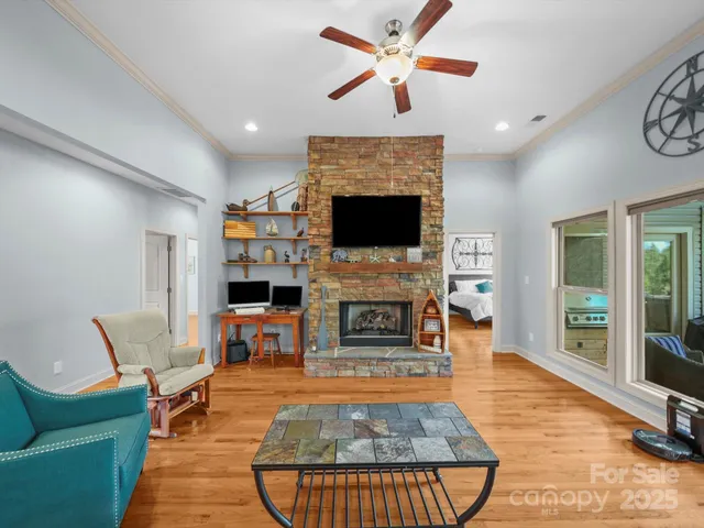 a living room with furniture a fireplace and a flat screen tv