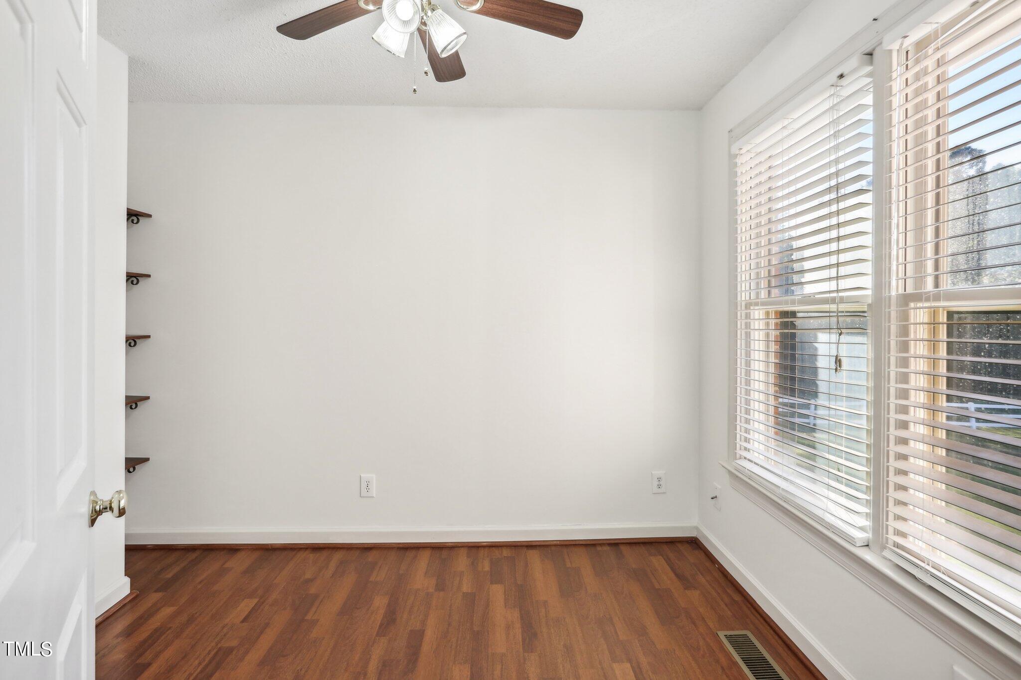 1517 Crickett Road Raleigh, NC 27610 - Photo 13 of 41 a view of room with window and hardwood floor