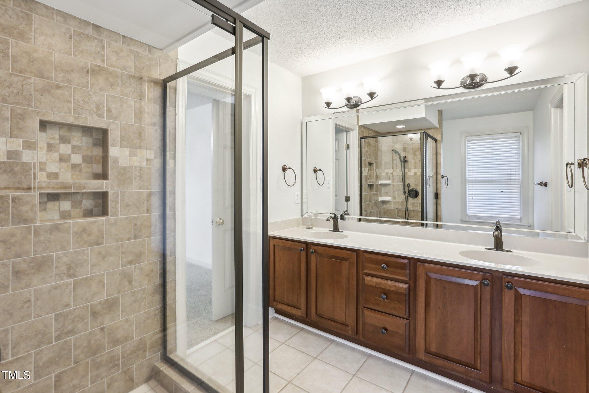 1517 Crickett Road Raleigh, NC 27610 - Photo 18 of 41 a spacious bathroom with a double vanity sink mirror and double