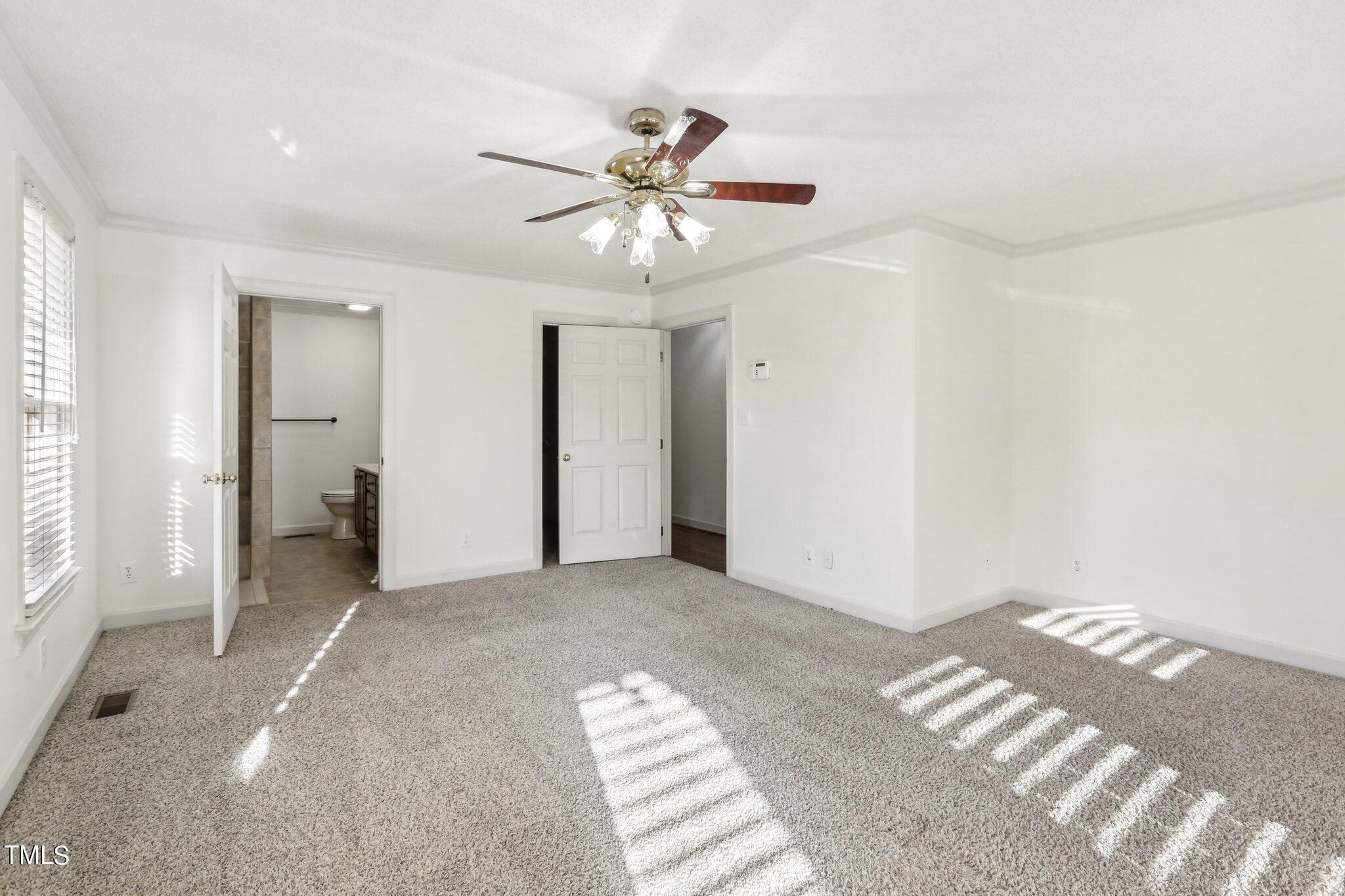 1517 Crickett Road Raleigh, NC 27610 - Photo 24 of 41 a view of a livingroom with a chandelier fan and closet