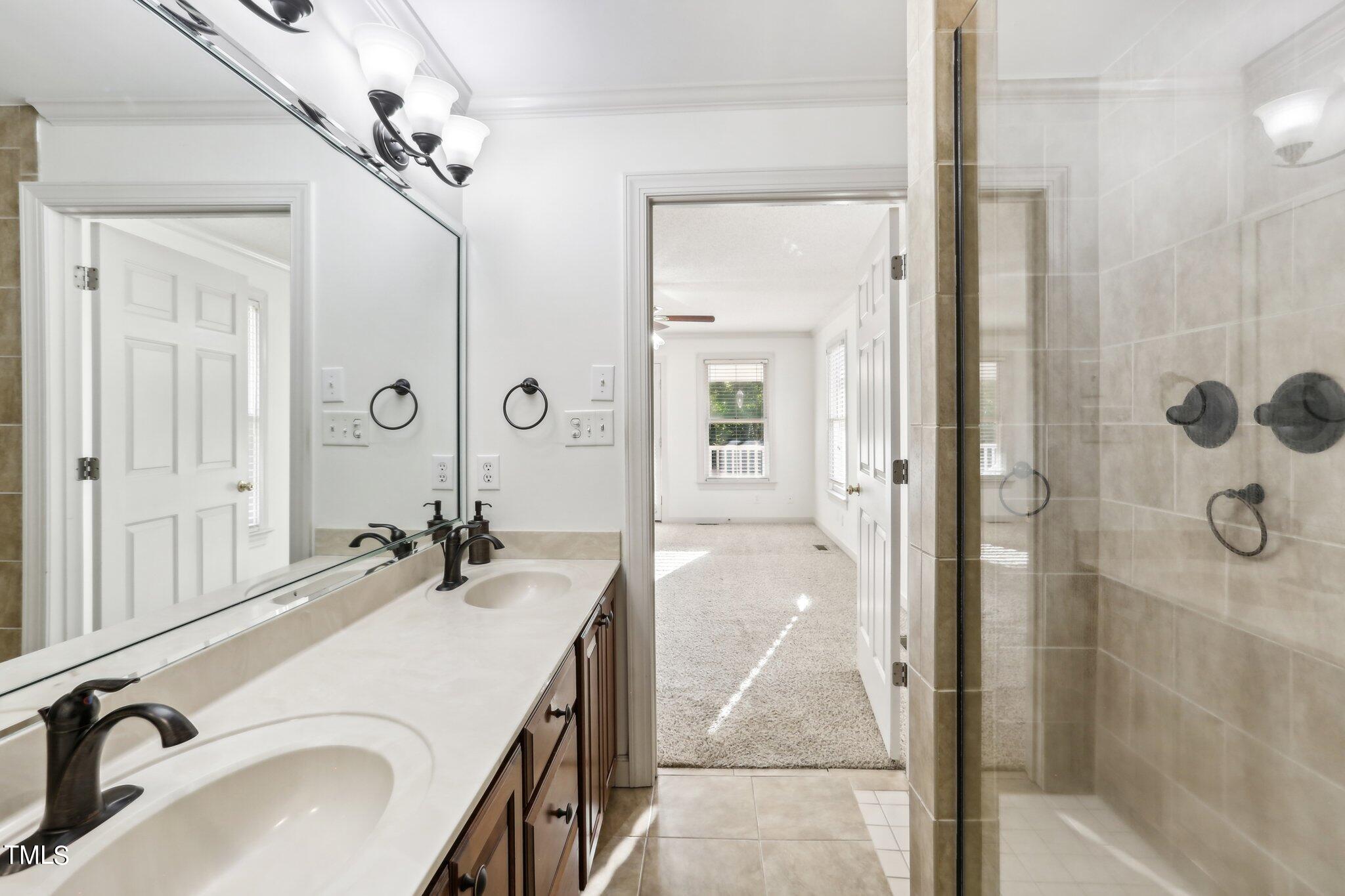 1517 Crickett Road Raleigh, NC 27610 - Photo 27 of 41 a bathroom with a sink and mirror with shower
