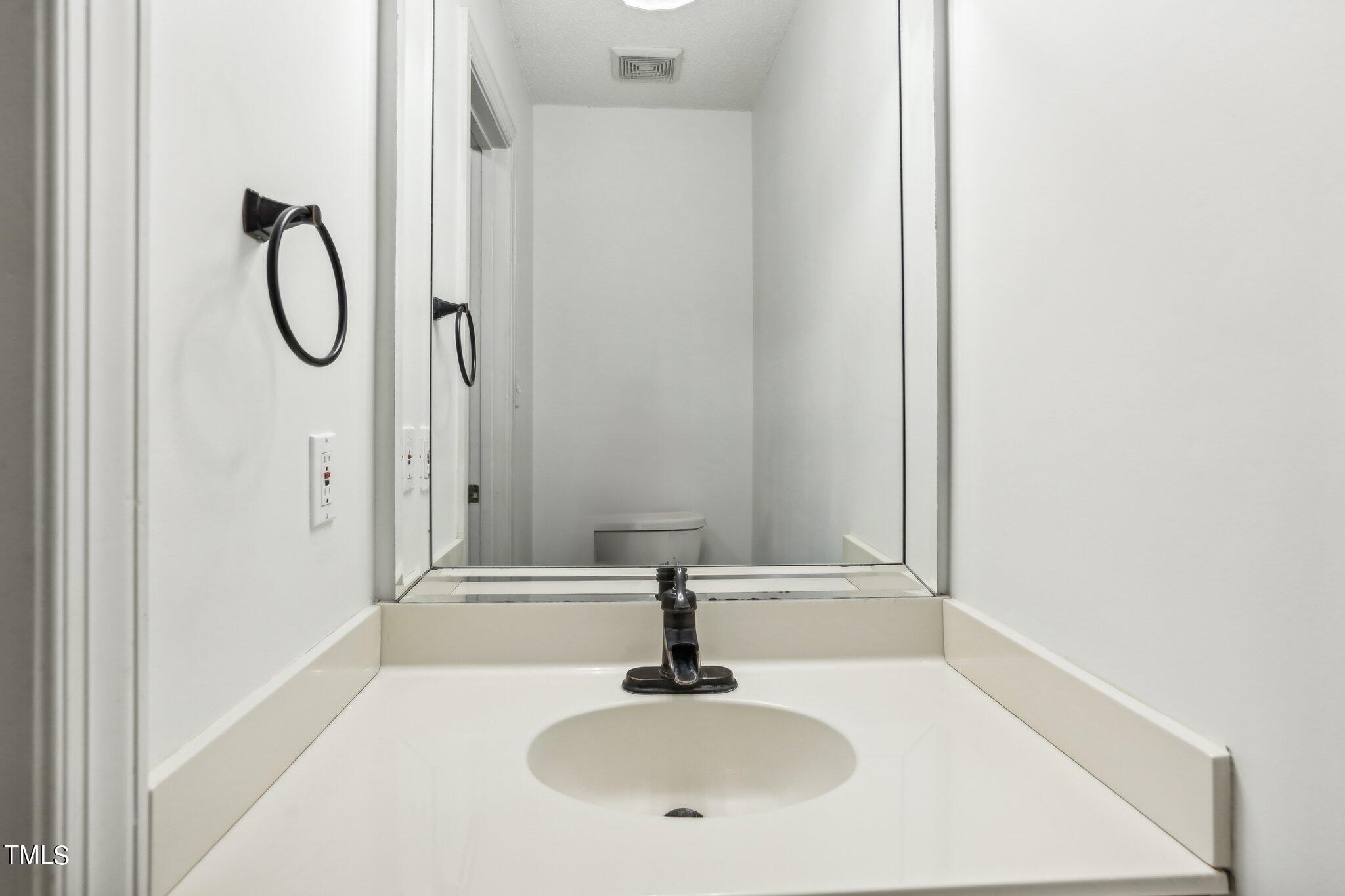 1517 Crickett Road Raleigh, NC 27610 - Photo 29 of 41 a bathroom with a sink and a mirror