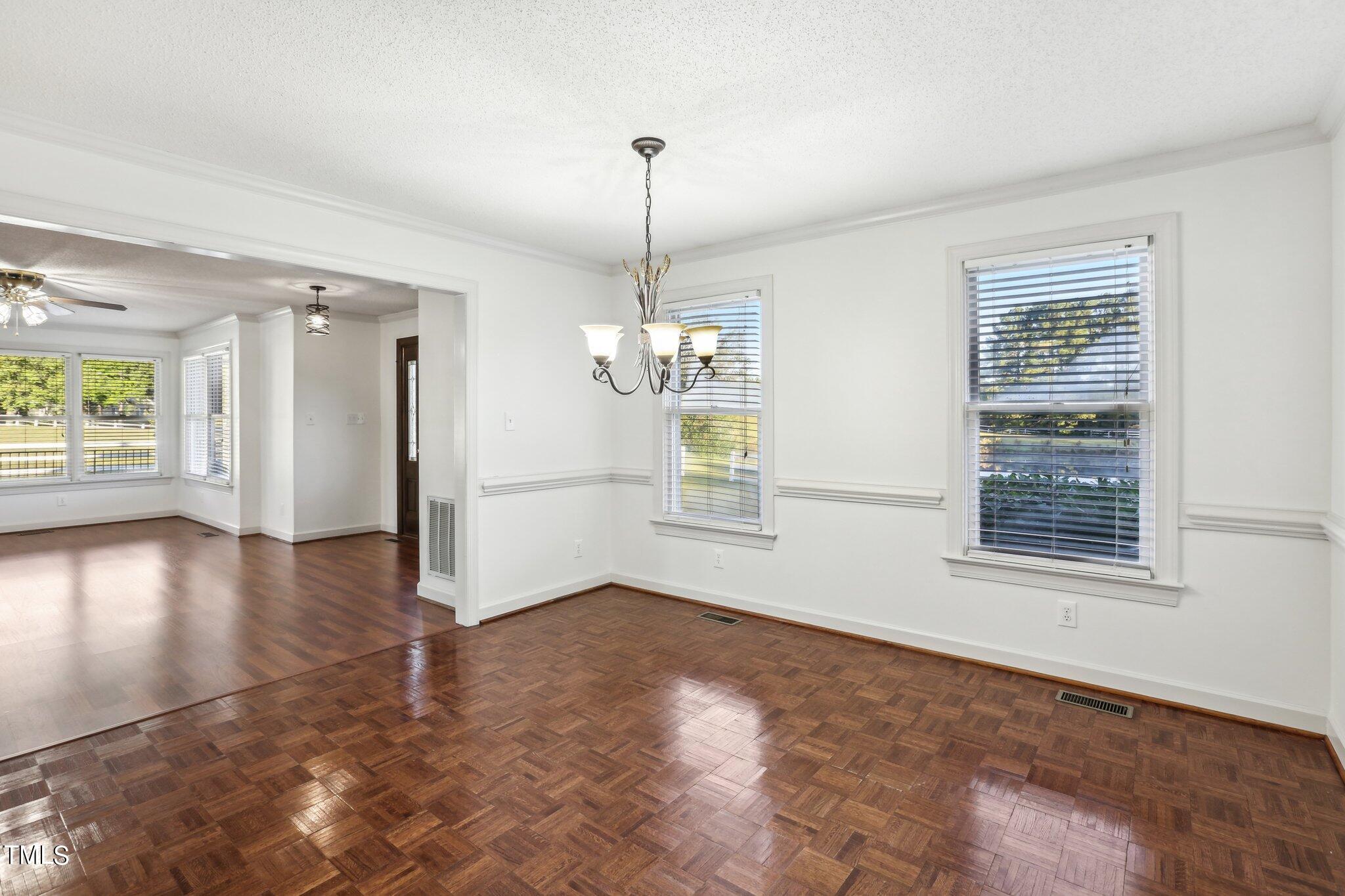1517 Crickett Road Raleigh, NC 27610 - Photo 10 of 41 a view of an empty room with window and wooden floor