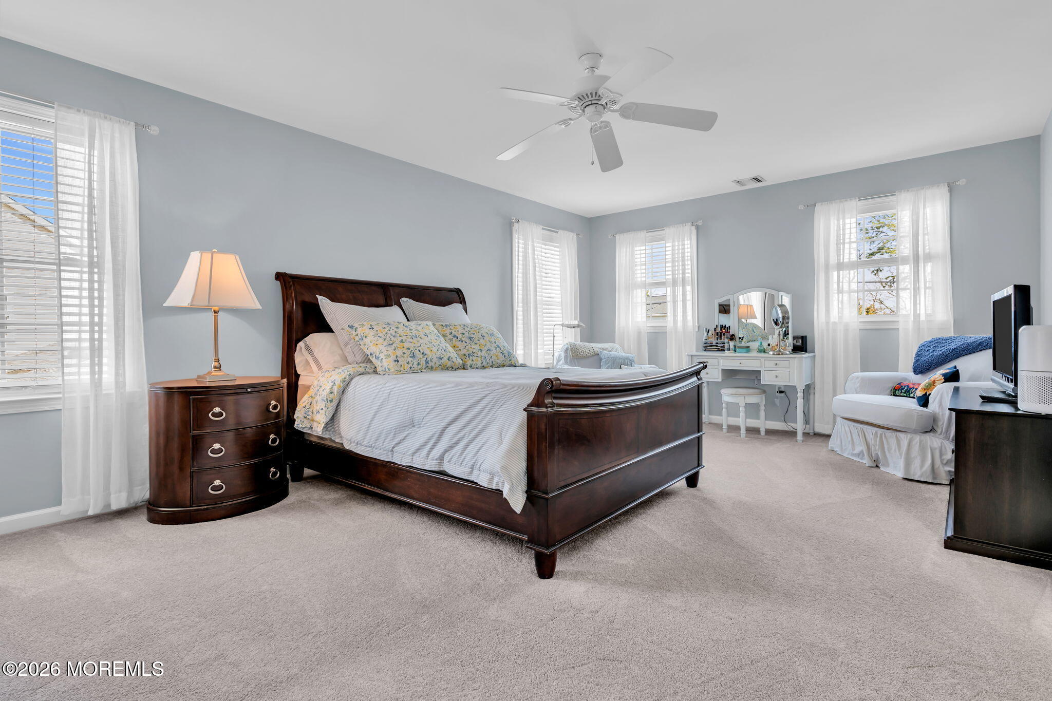 2404 Chestnut Street Point Pleasant, NJ 08742 - Photo 10 of 16 a spacious bedroom with a bed and a chandelier