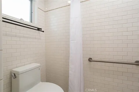 a bathroom with a toilet and shower