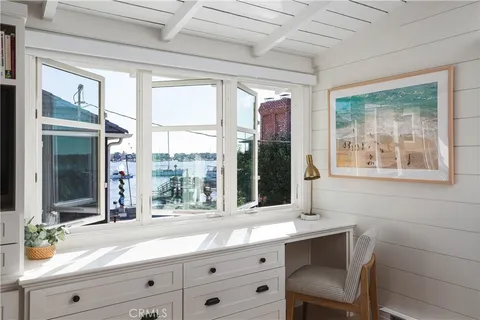 a bathroom with a sink and a large mirror next to a window