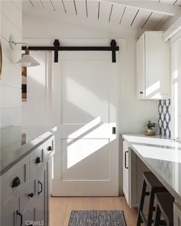 a utility room with cabinets and washer dryer