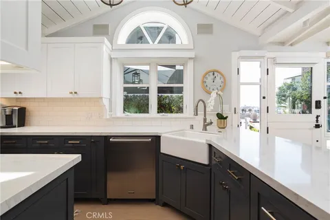 a kitchen with a sink cabinets and window