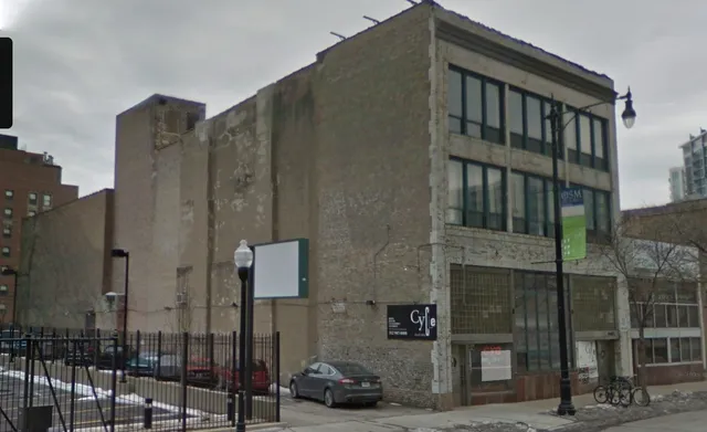 a view of a building with car parked