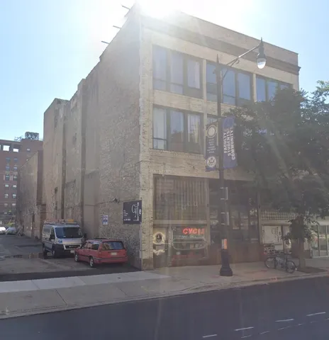a view of a tall building next to a road