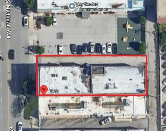 a front view of a multi story building with retail shops