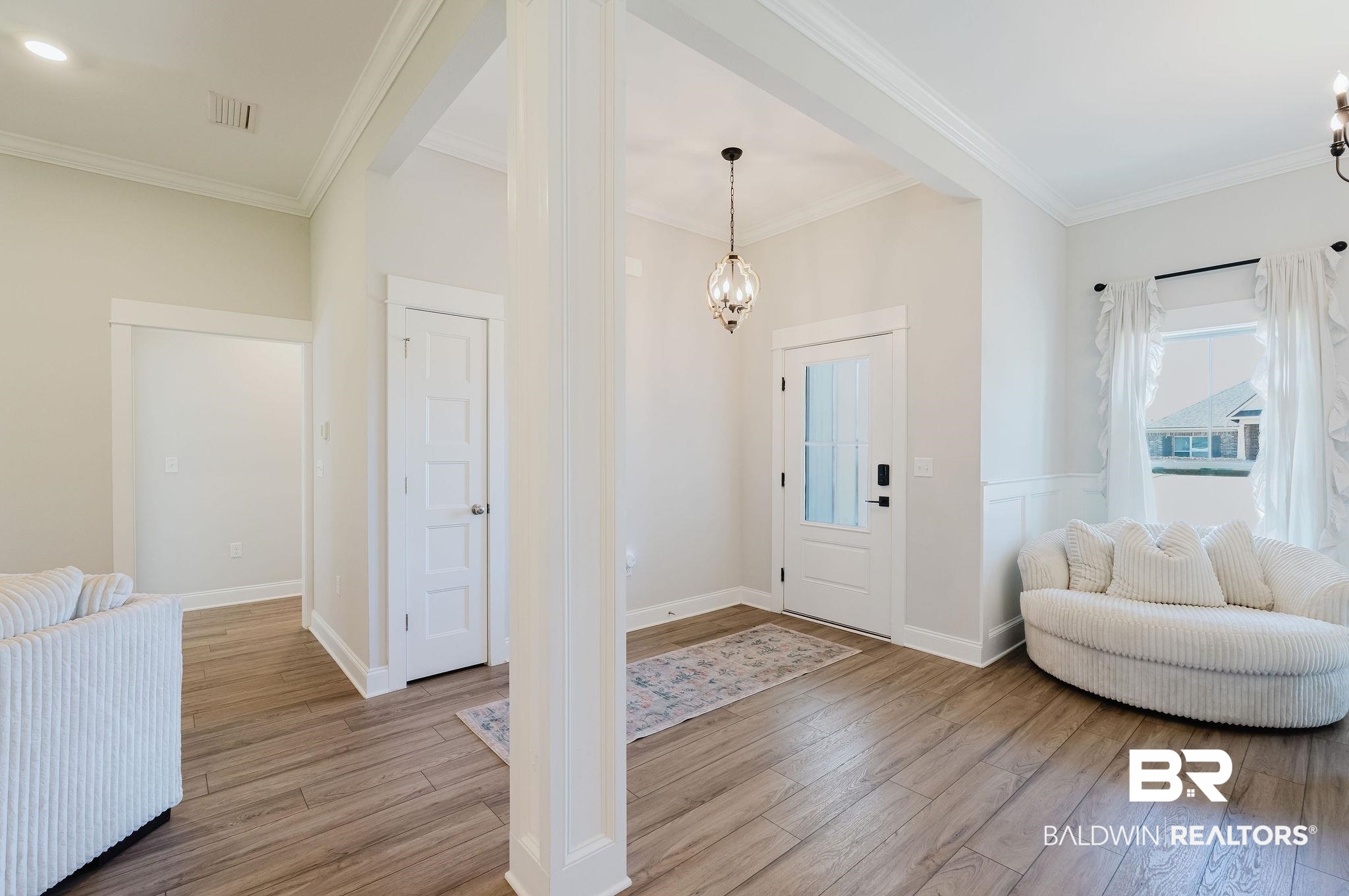 7872 Calverton Street Foley, AL 36535 - Photo 28 of 76 Entryway featuring wood-finish flooring, white paneled walls, and a decorative pendant light fixture
