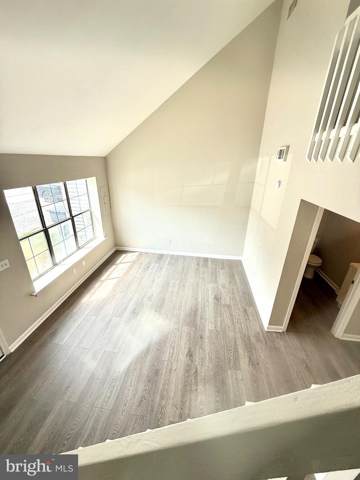 139 Spruance Road Dover, DE 19901 - Photo 11 of 20 view of wooden floor and windows in an empty room