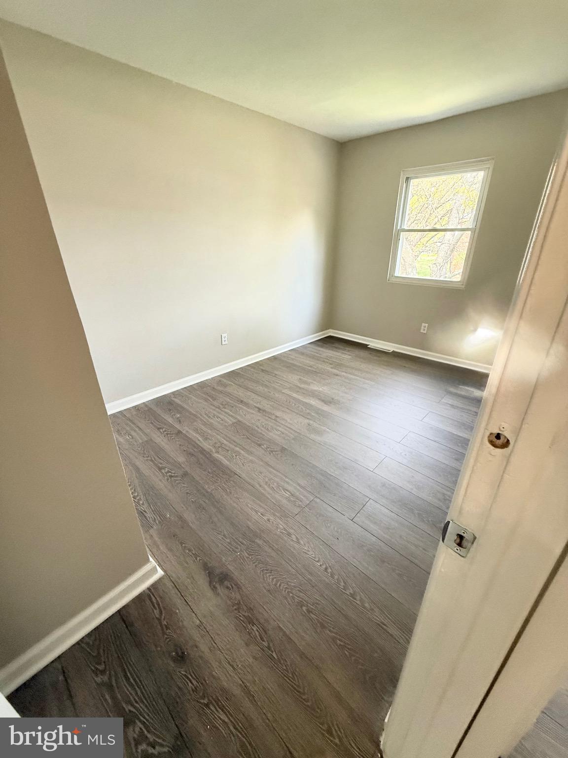 139 Spruance Road Dover, DE 19901 - Photo 15 of 20 an empty room with wooden floor and windows